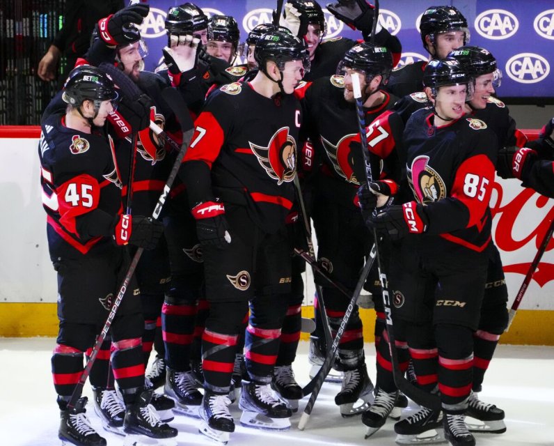 Ottawa Senators crowd around Brady Tkachuk (7) after his overtime goal against the Pittsburgh Penguins in an NHL hockey game Wednesday, Jan. 18, 2023, in Ottawa, Ontario. (Sean Kilpatrick/The Canadian Press via AP)(Sean Kilpatrick / Associated Press)